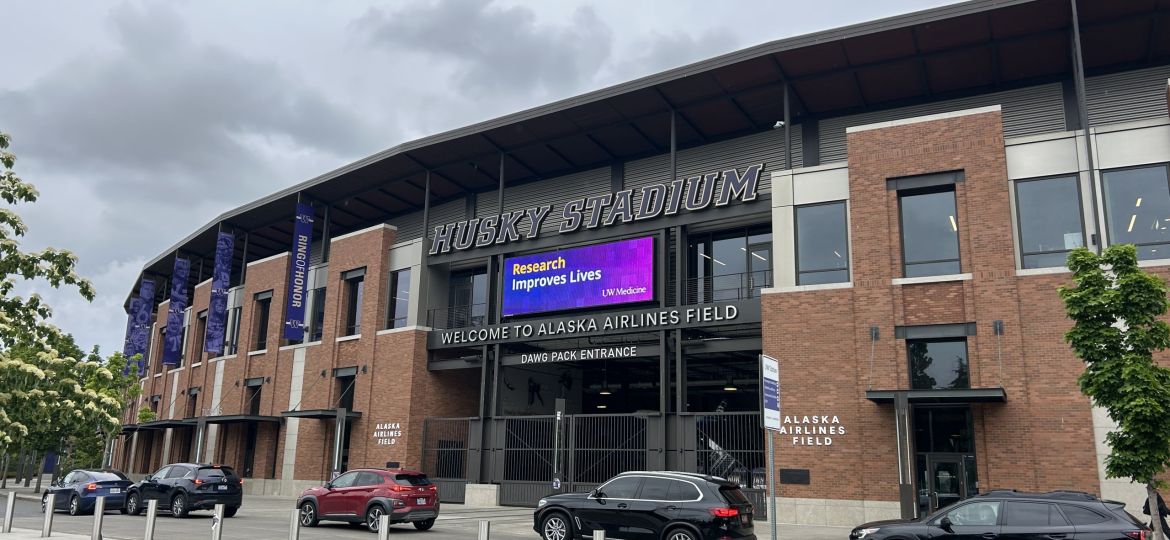 Image of Husky Stadium external billboard showing Research Improves Lives signage